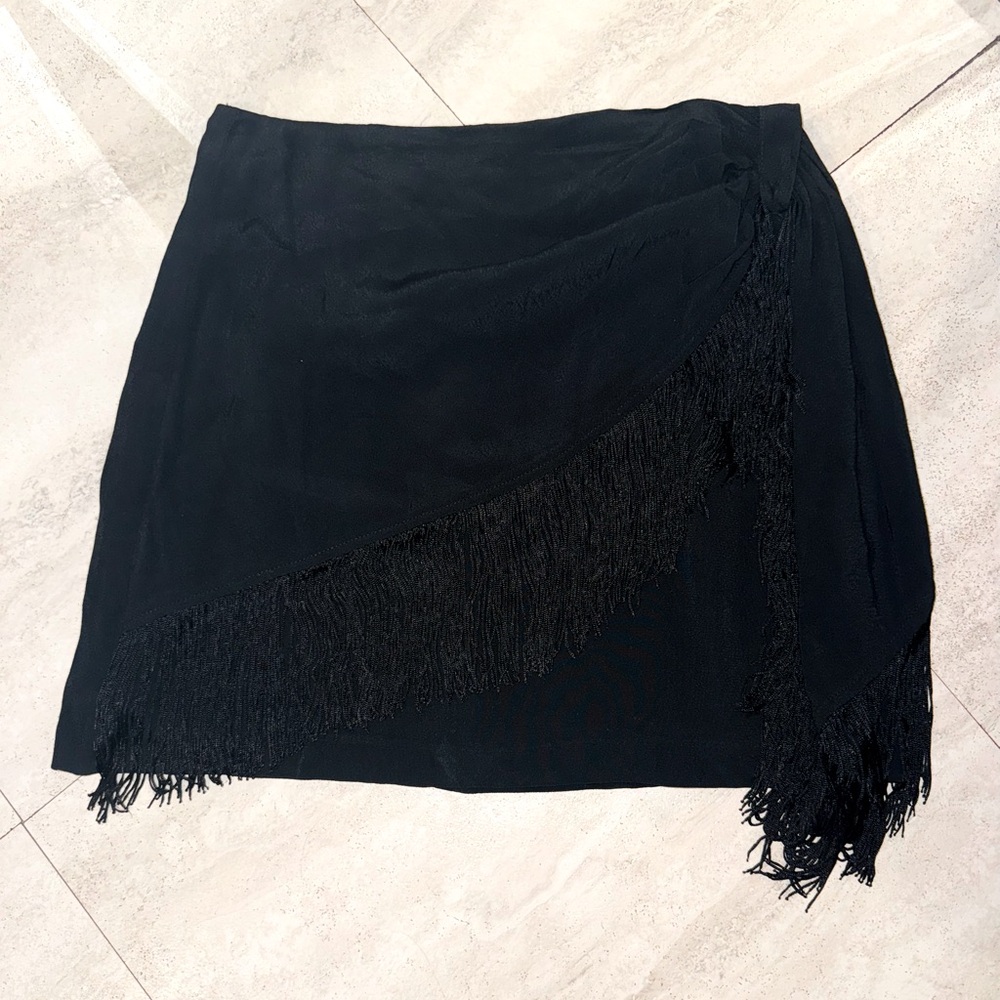 Cute fun fringe black skirt. Never worn.